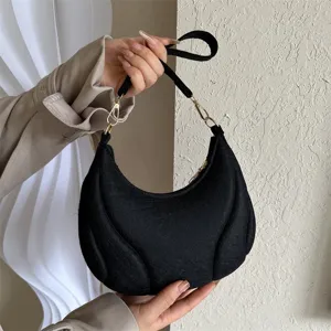 Black hobo shoulder bag for women, trendy French underarm bag with textured design.