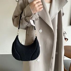Elegant black french underarm bag with subtle texture, stylish single shoulder bag for daily commute.