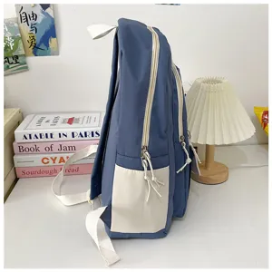 Casual student backpack side view, large capacity blue and white colorblock design, durable.