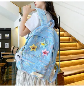 Cute blue backpack for school and travel with funny star plush charms and textured fabric.