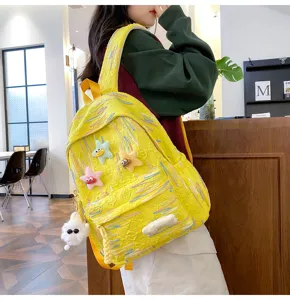 Korean style cute student backpack with colorful lines and funny star plush charms for travel.