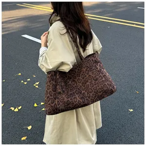 Detail view of a stylish leopard print canvas tote bag in daily casual street scene use.