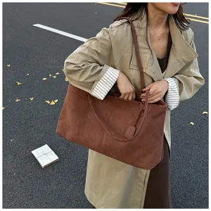 Detailed close up of brown suede slouchy tote bag, casual daily shoulder handbag style