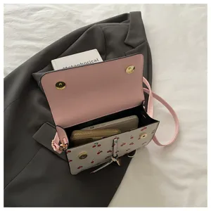 Vue détaillée du sac bandoulière imprimé cerise pour femme avec intérieur rose, design chic.