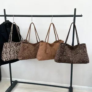 Detailed view of fashionable leopard print tote bags and casual shoulder bags on display.