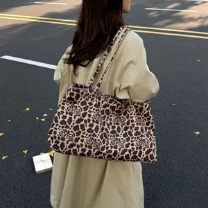 Detailed shot of a stylish leopard print tote bag worn on shoulder, casual everyday carry.