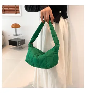 Green quilted puffer underarm cloud bag detail view showing soft texture and stitching.