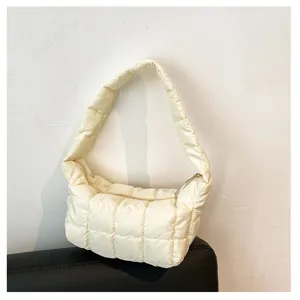 Puffy quilted shoulder bag detail, soft off-white cloud handbag close-up showcase.