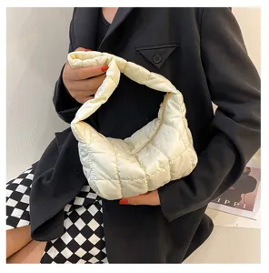 White quilted puffer underarm bag, soft cloud handbag detail showing texture and puff design.