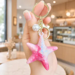 Cute pink starfish keychain with pearl charm, acrylic iridescent bag pendant for women and girls.