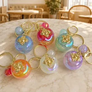 Cute acrylic persimmon keychain and bag charm, colorful shiny sphere pendant with gold hardware.