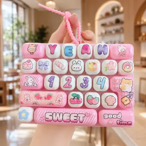 Close up of pink cute stress relief keyboard keychain with cartoon print and numbers.