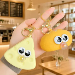 Silicone cheese and bread stress relief keychain detail, cute googly eyes bubble toy pendant.