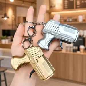Mini flint gun keychain decompression toy with rotating gears and sparkling effect for kids.