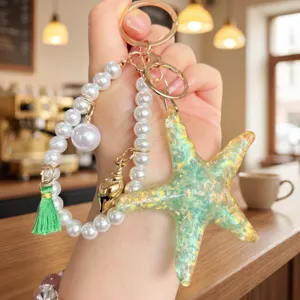 Starfish pearl keychain pendant, summer ocean style resin charm with tassel for bags.