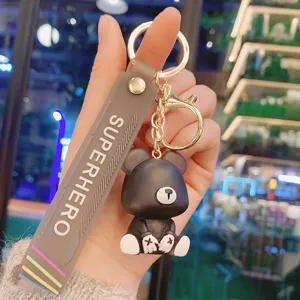 Cute black bear keychain detail view, resin cartoon toy charm with gold tone hardware.