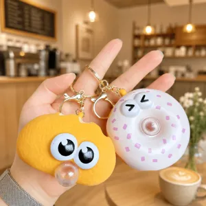 Cute cartoon decompression pinch toy keychain detail view, soft silicone material.