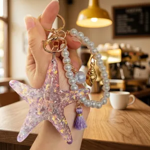 Detailed view of summer ocean style starfish pearl bracelet keychain, resin pendant charm accessory.