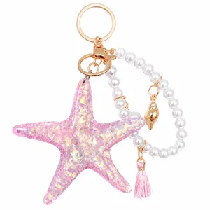 Cute pink glitter starfish keychain with pearl strap, shell pendant and tassel for summer.