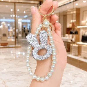 Detailansicht eines funkelnden Strass Hasenkopf Schlüsselanhängers mit Perlen Handschlaufe.