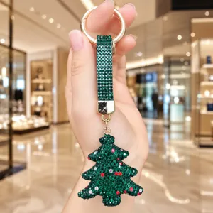 Detailed close-up of the sparkling rhinestone Christmas tree keychain pendant with gold ring.