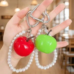 Detailed view of creative simulation apple keychain with pearl strap and heart hook.