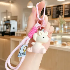 Close-up detail of cute gradient unicorn keychain with pink woven lanyard and metal clasp.