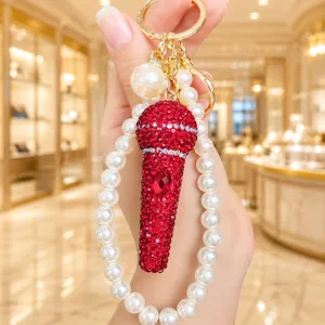 Prachtige strass microfoon sleutelhanger met parelband luxe tas bedel prachtig detail