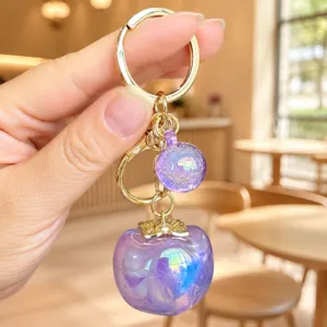 Purple persimmon keychain detail view, gold hardware, cute acrylic bag pendant accessory