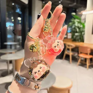 Cute quicksand acrylic keychain with adorable cartoon doll design, perfect bag charm and accessory.