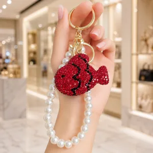 Exquisite rhinestone red fish keychain pendant with pearl chain strap for bags or phone.