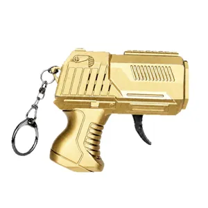 Mini metal flint gun keychain, creative decompression toy with spark gear, gold color.