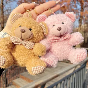 Cute plush teddy bear keychain with plaid bow, soft stuffed doll bag pendant for students.