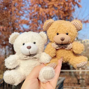 Plush teddy bear keychain featuring a cute plaid bow, soft fluffy bag pendant for gifts.