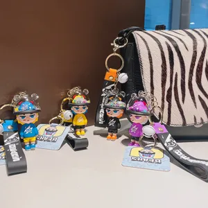 Cute PVC astronaut cartoon figure keychain with strap and helmet design, ideal bag pendant.