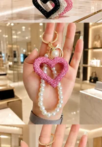 Rhinestone heart keychain with pearl strap detail showing sparkling crystals and elegant pendant.
