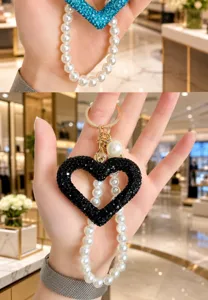 Pearl crystal heart keychain bag charm, handmade sparkling rhinestone pendant for stylish bags.
