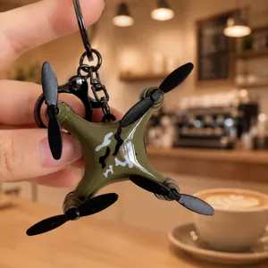 Mini drone keychain, creative foldable quadcopter backpack pendant, stylish metal keyring accessory.