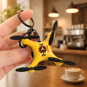 Mini drone keychain, yellow foldable aircraft backpack pendant, cool student accessory.