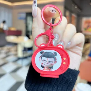 Close-up detail of a cute red cartoon character TV keychain, showing vibrant pendant design.