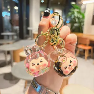 Cute liquid quicksand acrylic keychain with gold hardware, perfect backpack charm and accessory.