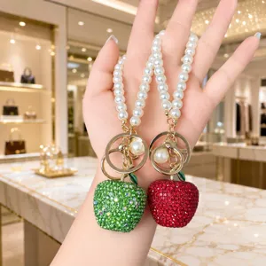 Rhinestone apple bag charm with pearl chain, sparkly crystal fruit key ring for women.