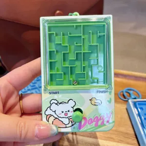 Detailed close-up shot of the mini green maze puzzle keychain, highlighting the plastic tracking design.