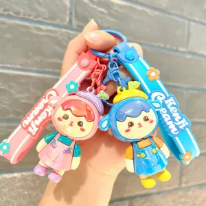 Detail shot of cute electroplated cartoon girl keychains with cherry hats and decorative straps.