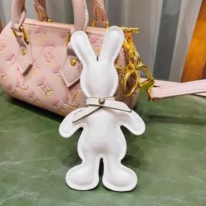 White PU leather rabbit keychain with bow tie, cute bag charm and car key pendant for women.