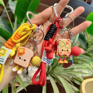 Detailed view of cute toast keychain with woven lanyard and mini charms for bag decoration.