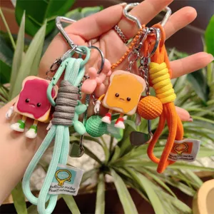 Cute toast bread keychain with woven lanyard and cartoon charms, trendy cute student bag pendant.