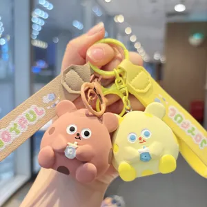 Close-up detail of cute resin cheese mouse keychain with colorful strap and bubble tea doll.