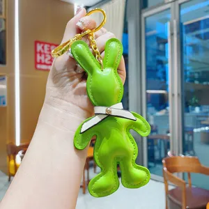 Creative PU leather rabbit keychain, cute animal bag pendant with bow tie and gold hardware.
