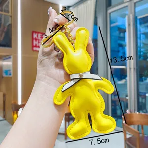 Cute yellow PU leather rabbit keychain with bow tie, stylish bag pendant and car key accessory.